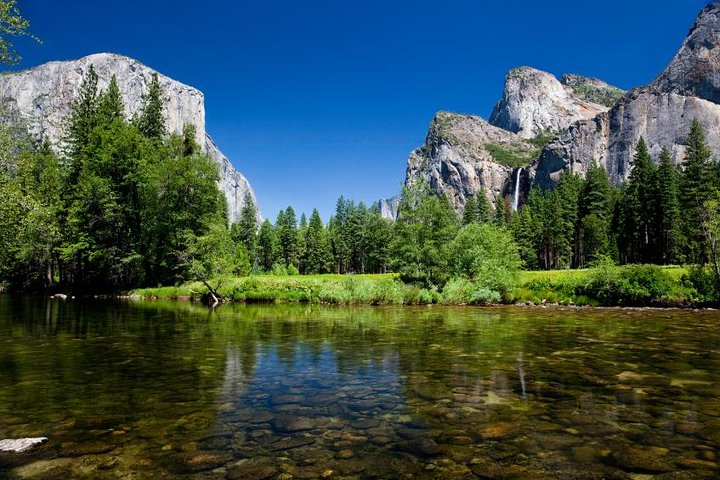 Discover the majesty of Yosemite with its towering cliffs and serene waters perfect for those seeking adventure and natural beauty on a memorable California coast tour.